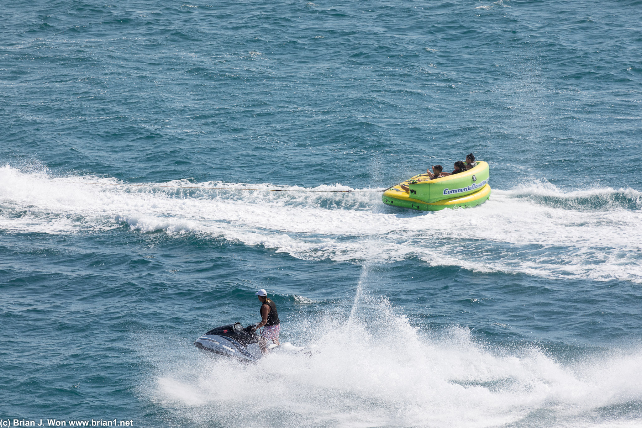 Inflatable rafts being pulled by jetski's.