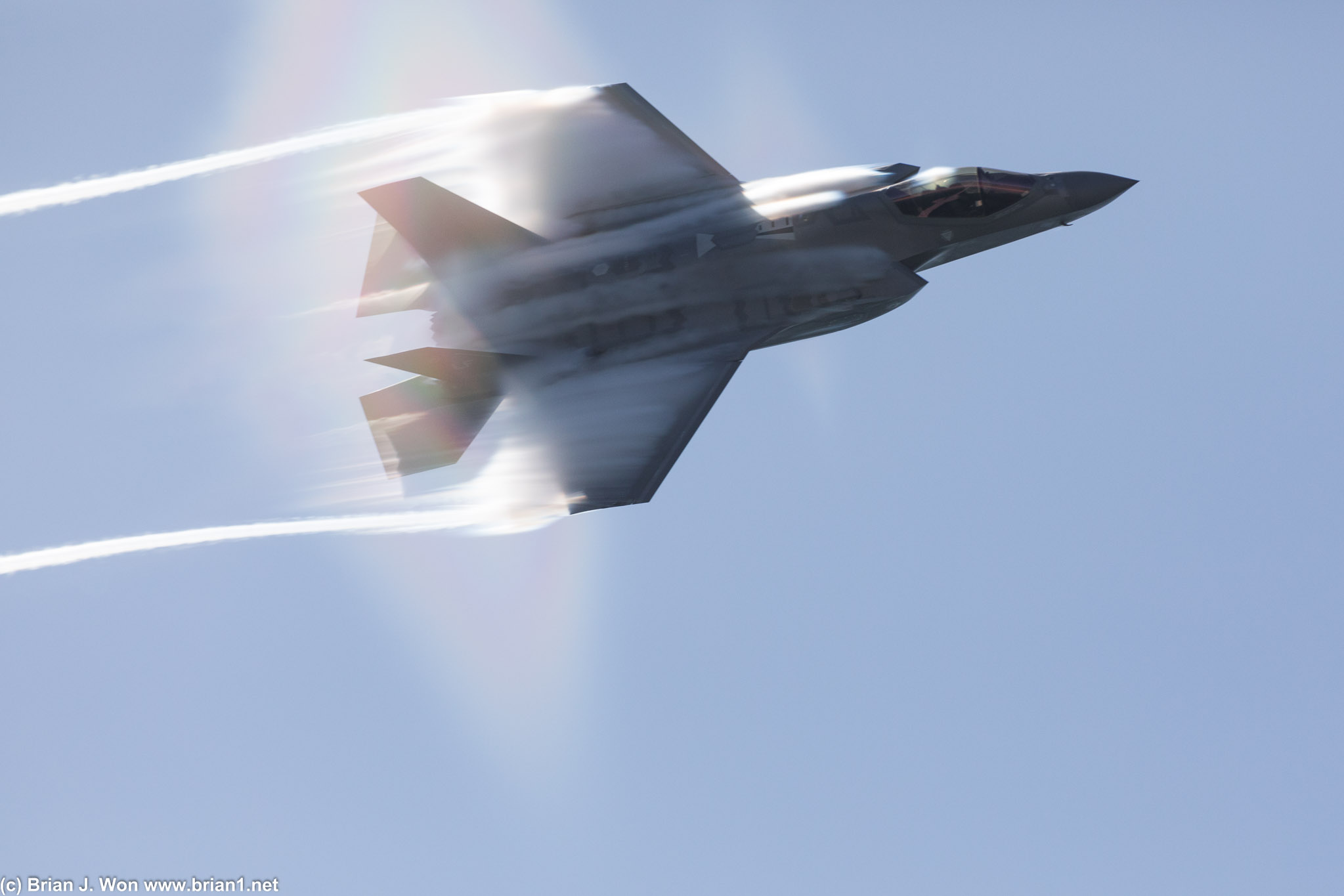 F-35A punching through its vapor cone at transonic speed.