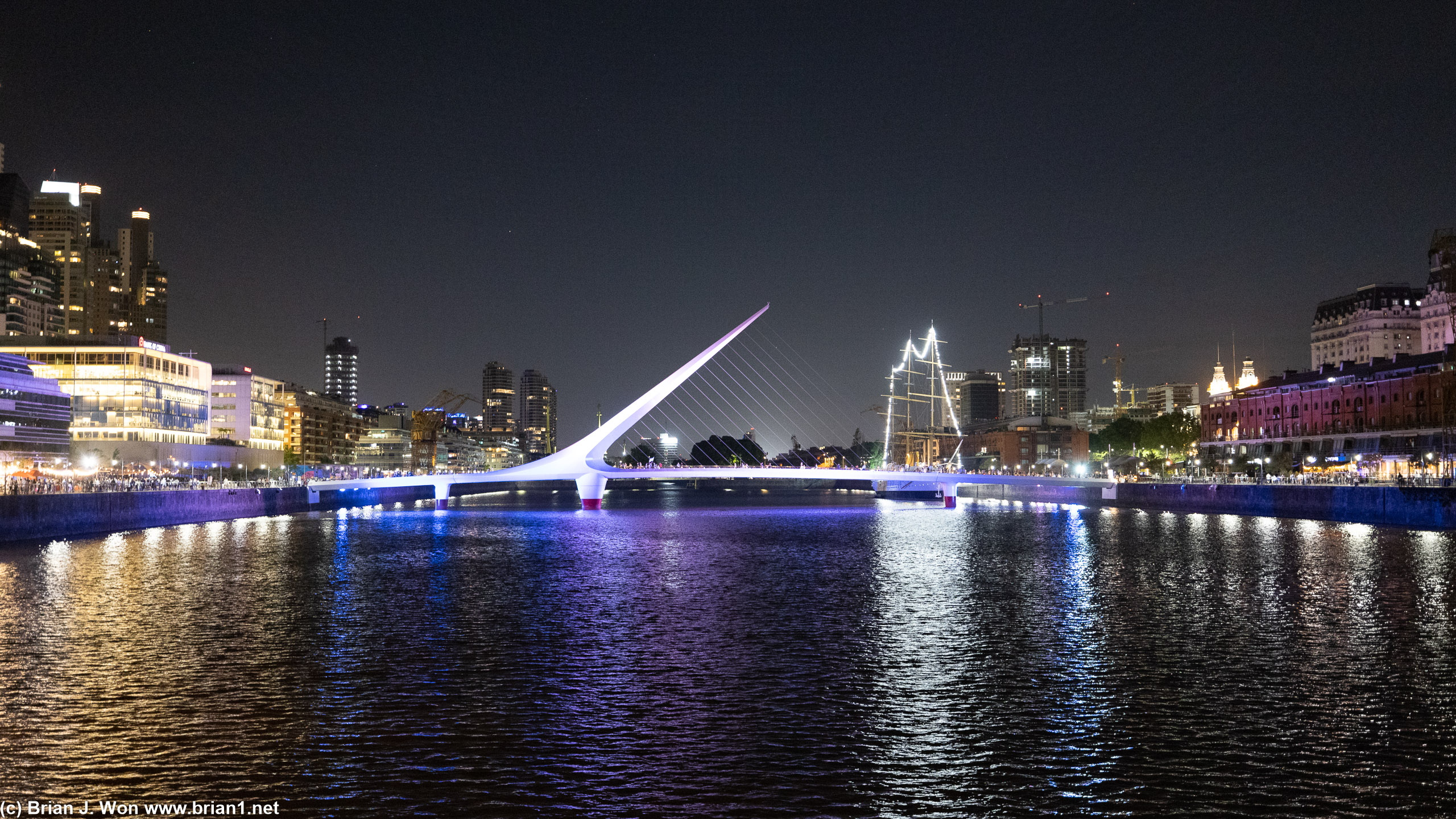 Puente de la Mujer lit up at night.