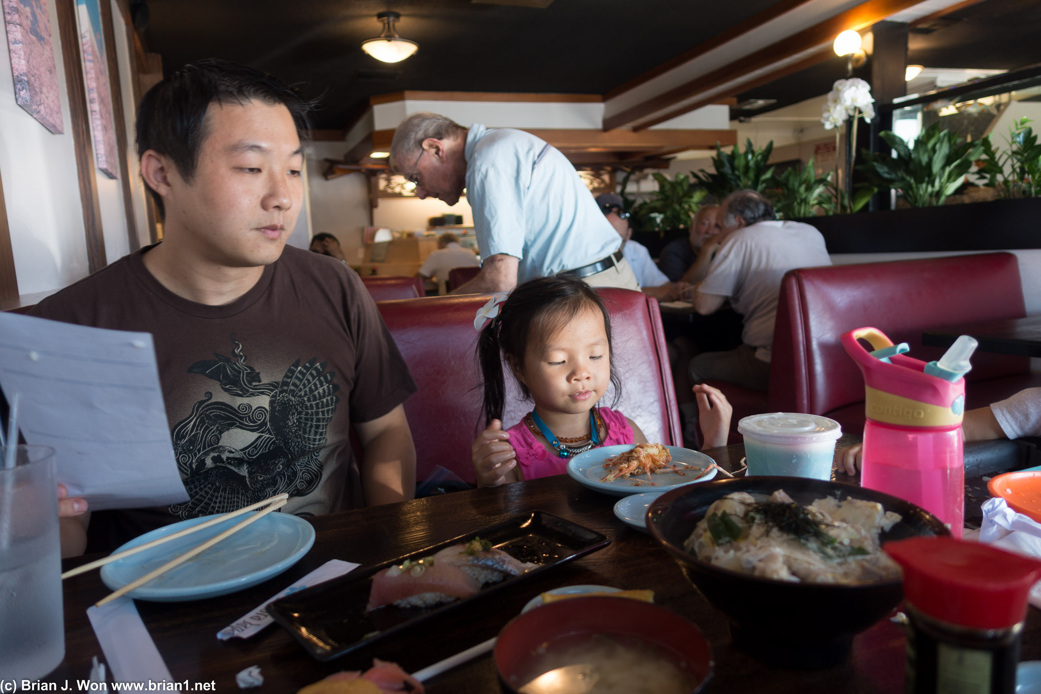 Father and daughter both love sushi.
