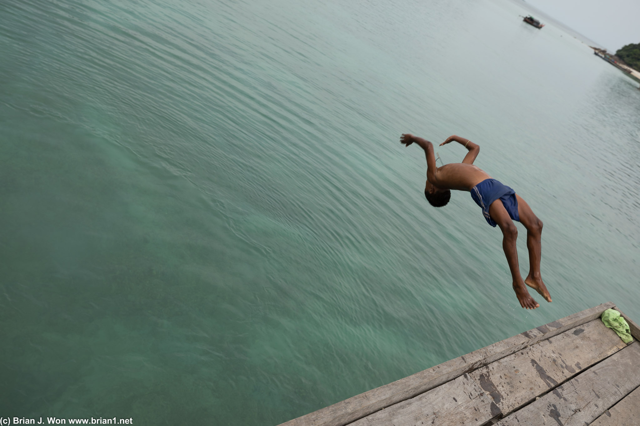 Kids jumping in to the sea to cool off.