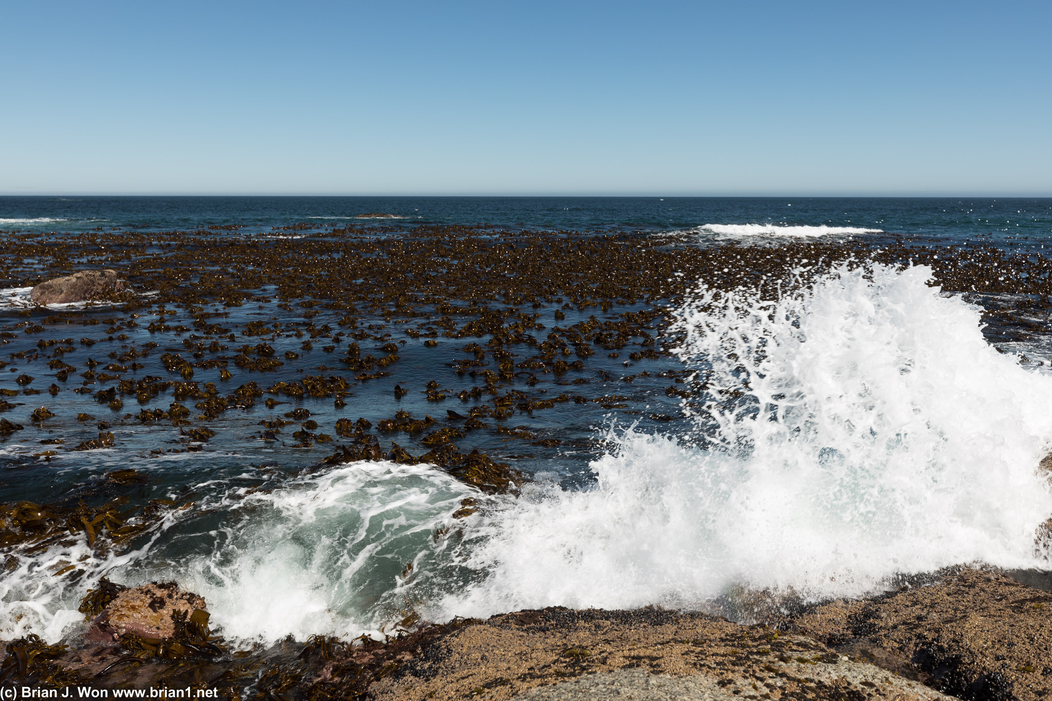 Crashing into shore.