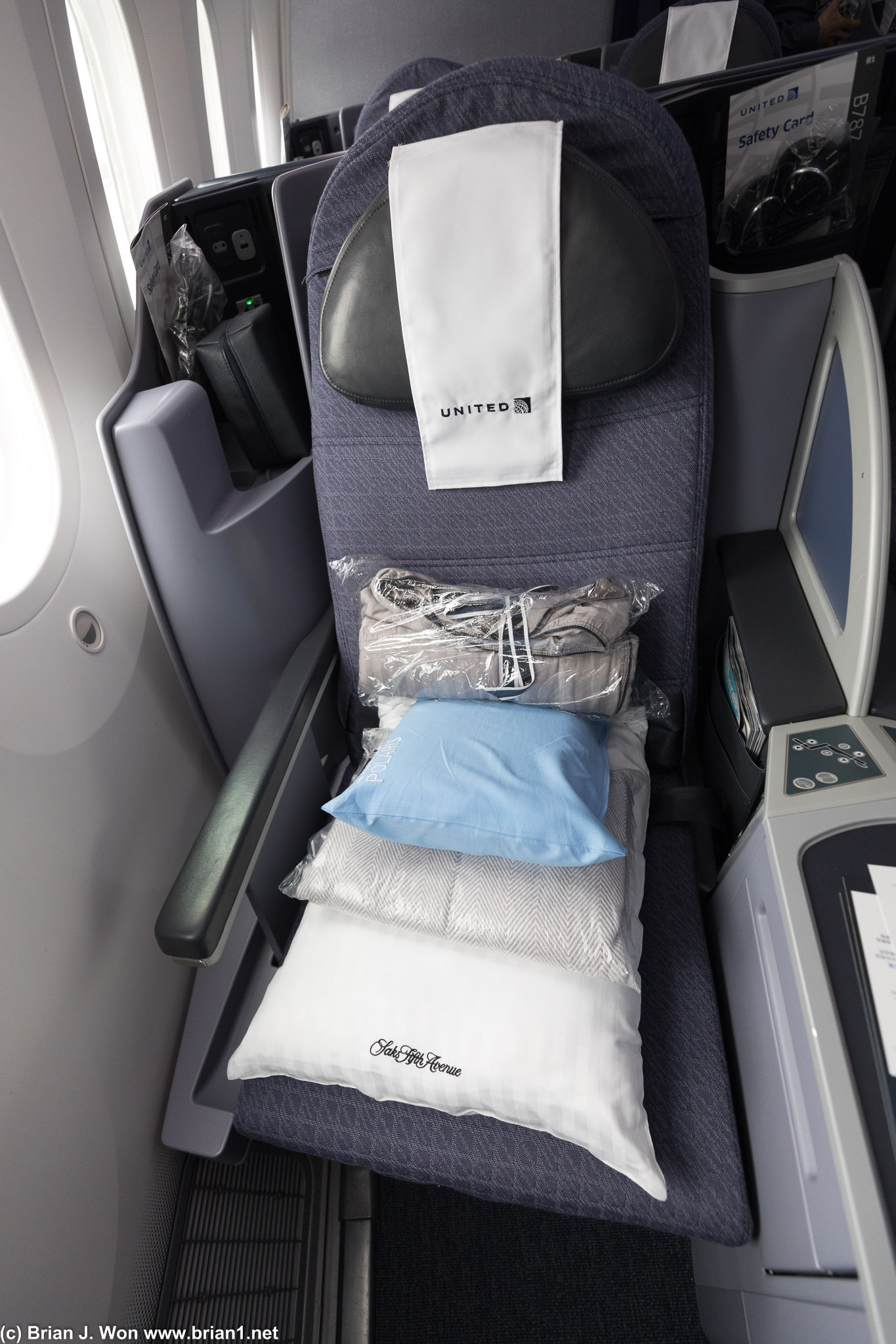 Two blankets, two pillows, not enough storage. (thank goodness for overhead bins!)