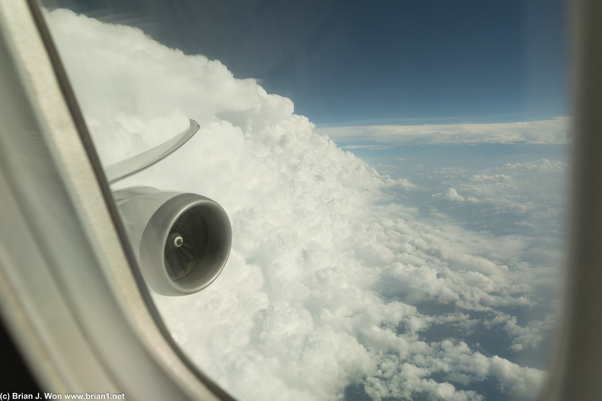 Emerging from a wall of clouds over Singapore.