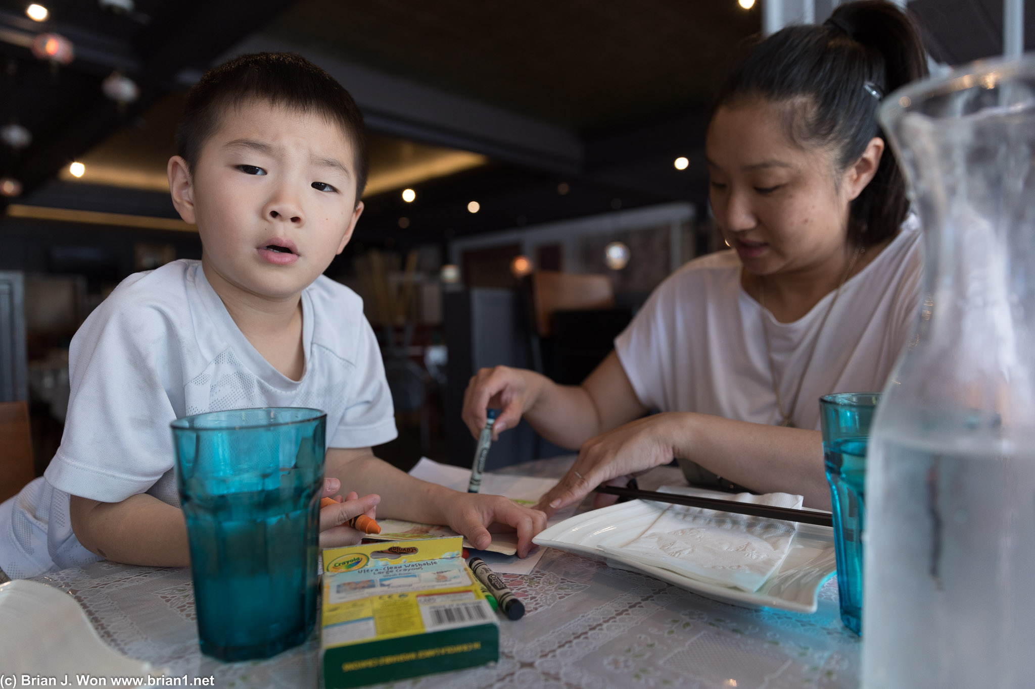 Mason seems skeptical of whatever is distracting him from his coloring.