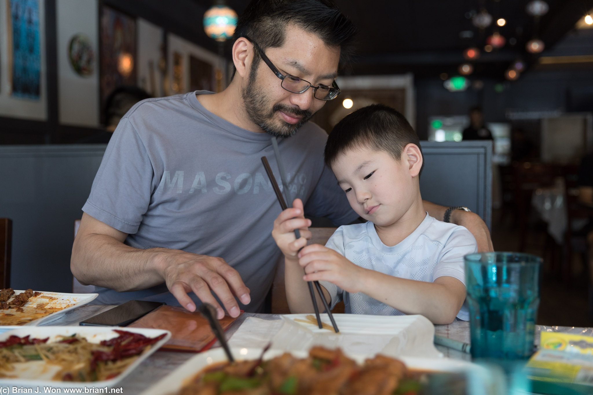 Teaching how to use chopsticks.