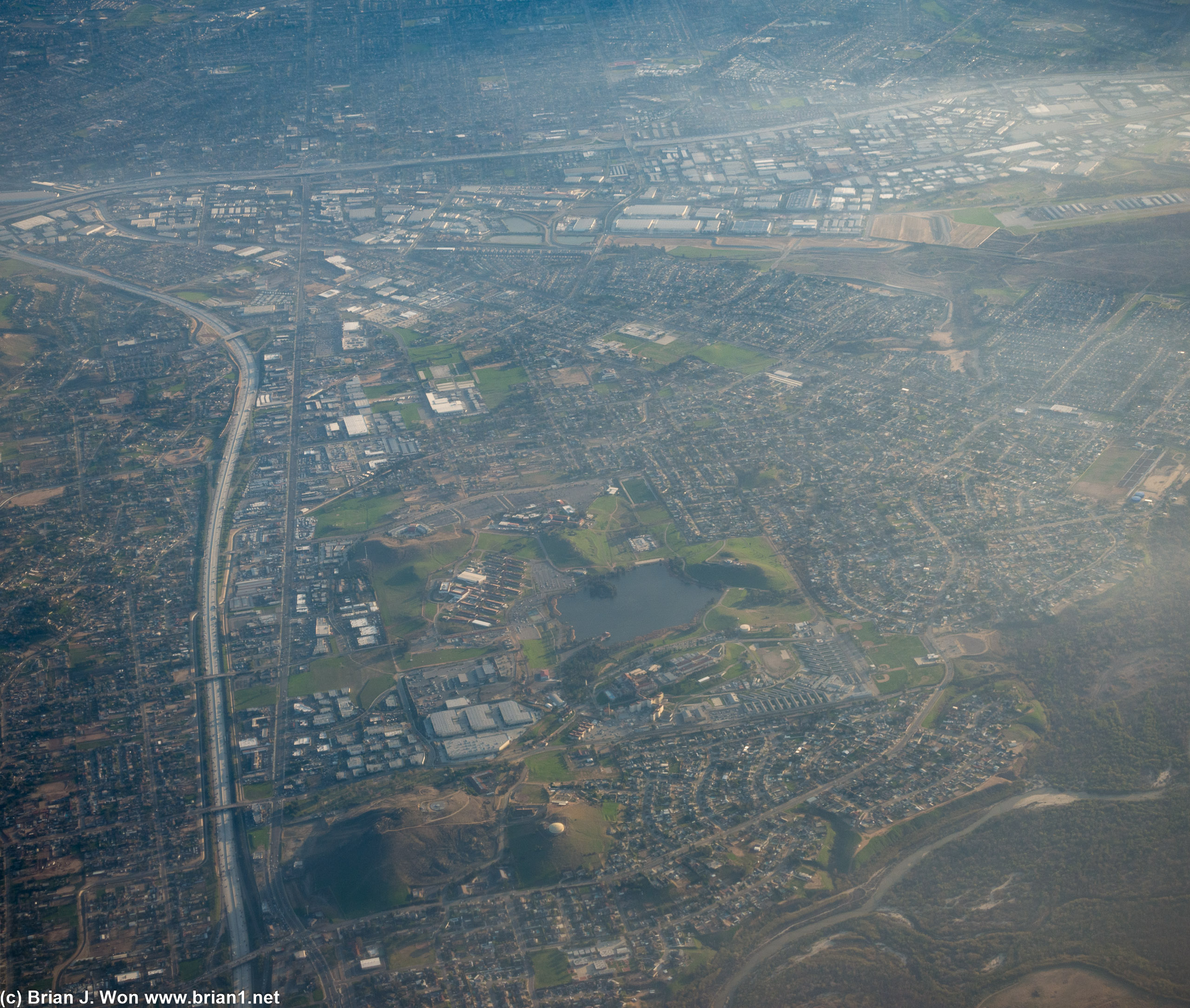 Lake Norconian with rows of massive warehouses closer to CA-91.