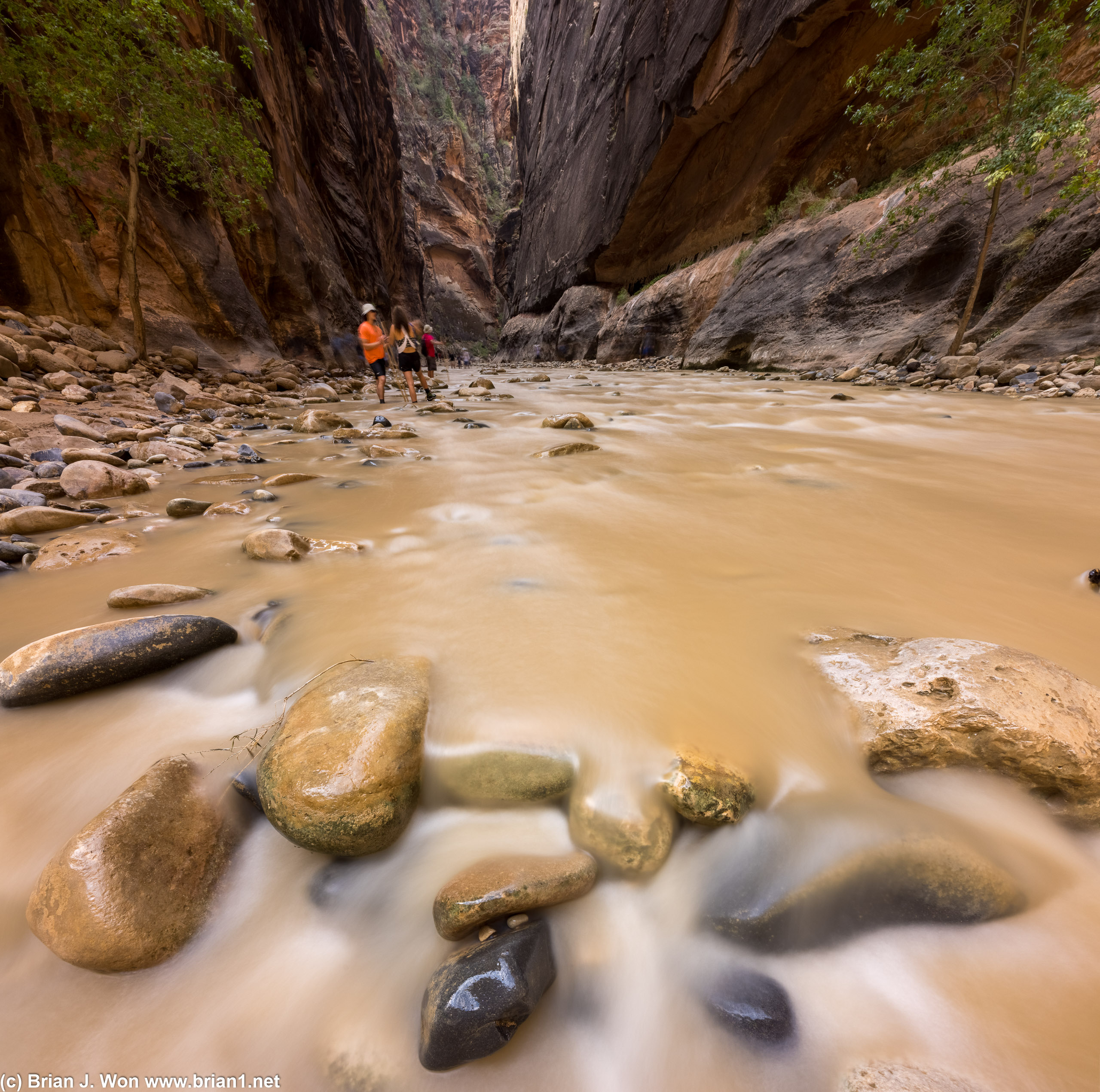 Gently flowing over the rocks.