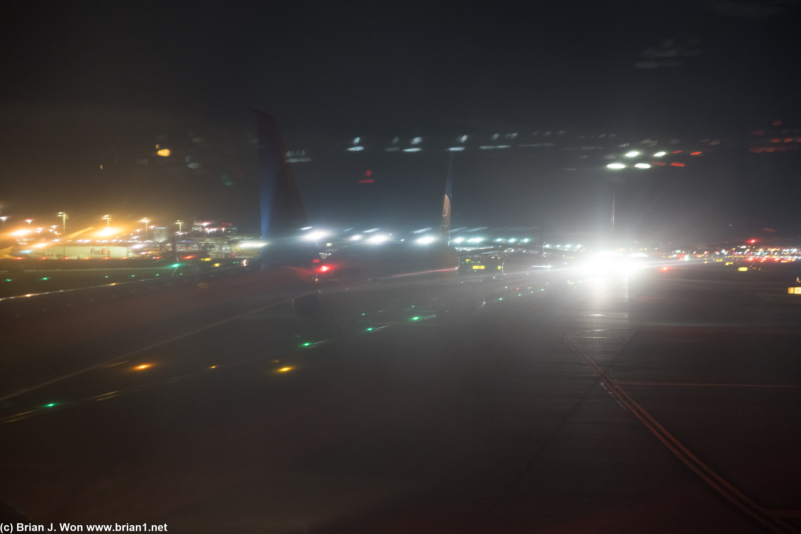 Long line of airplanes behind us, all waiting to take off.