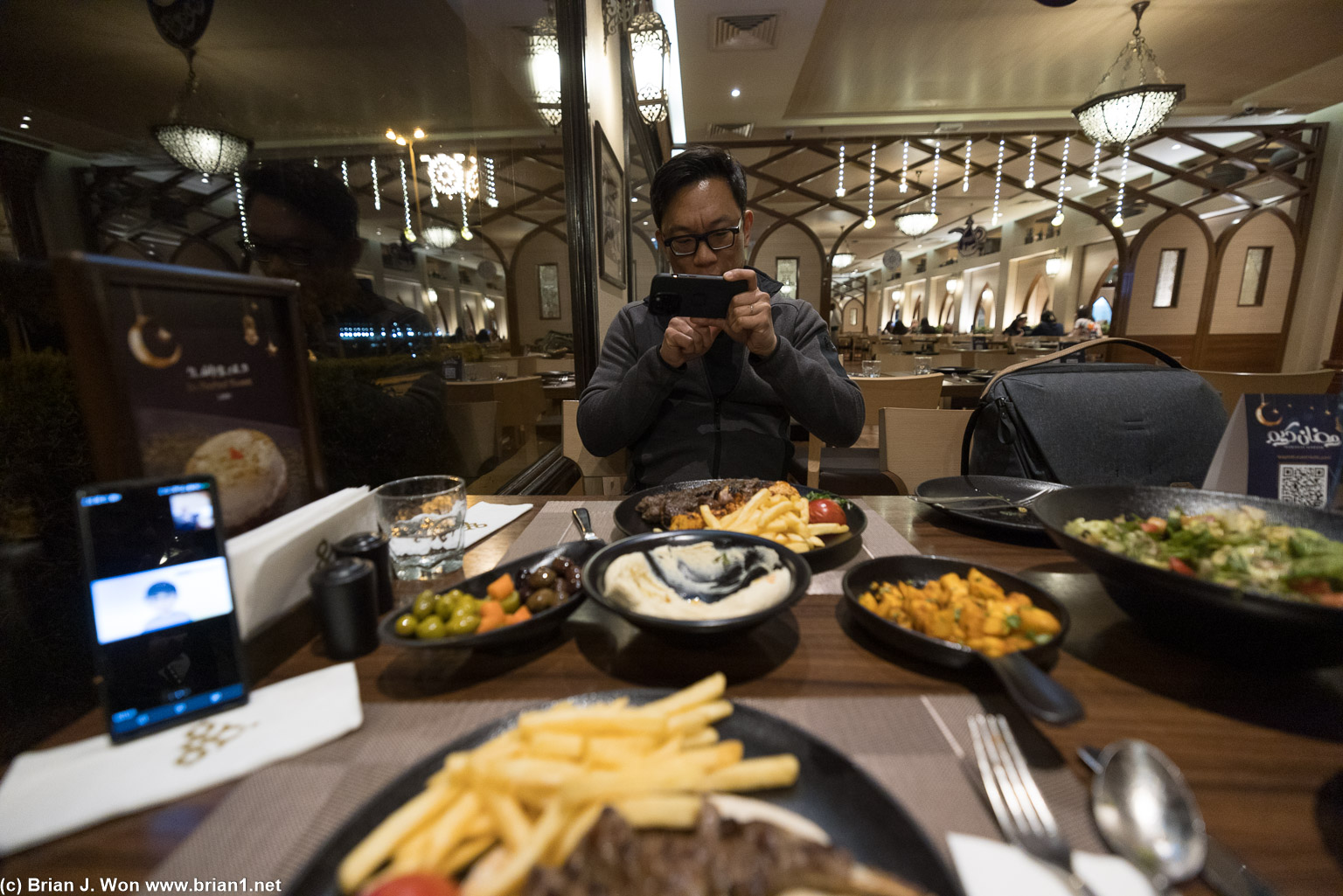 Photographing food and taking meetings.