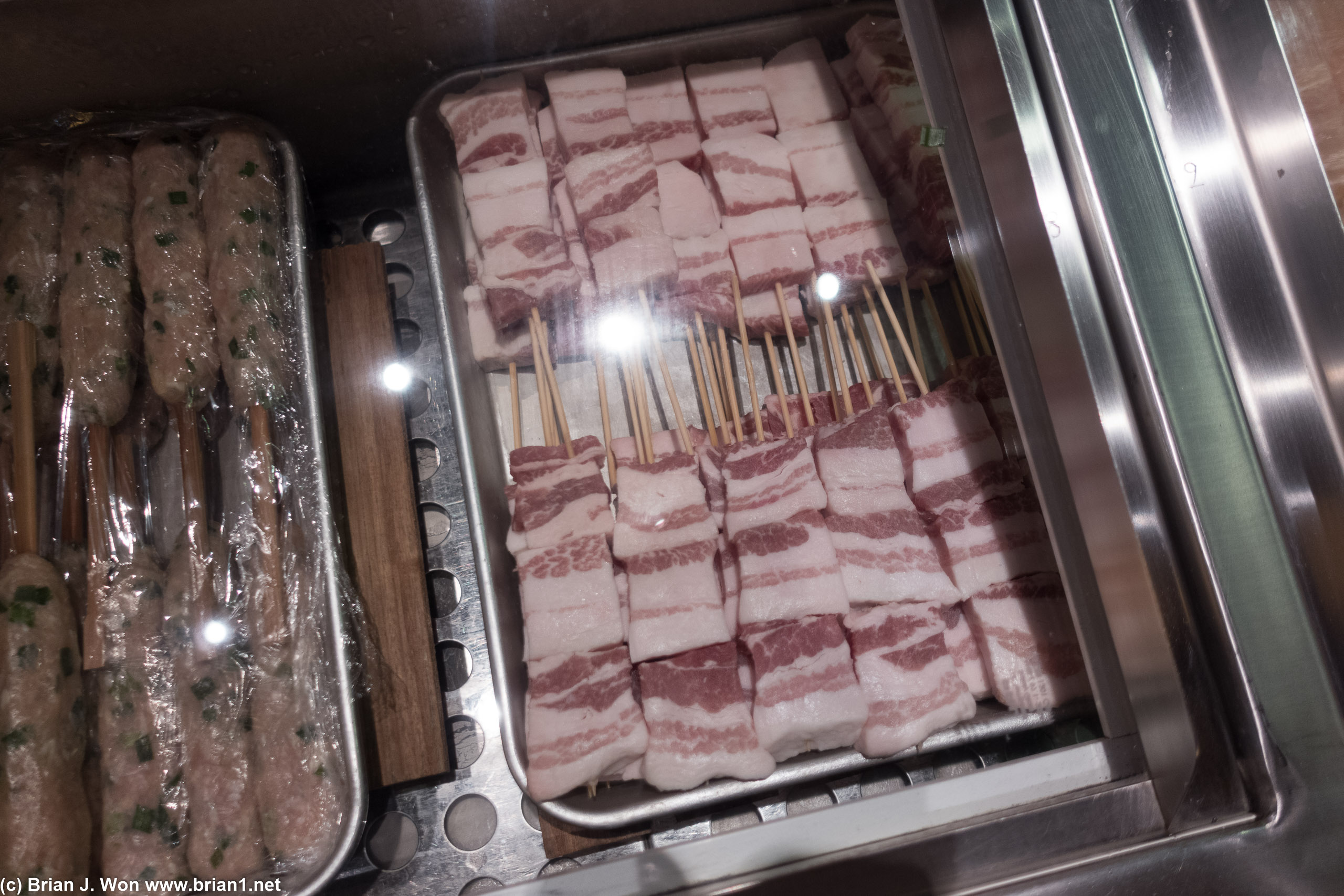Pork belly next to ground chicken.