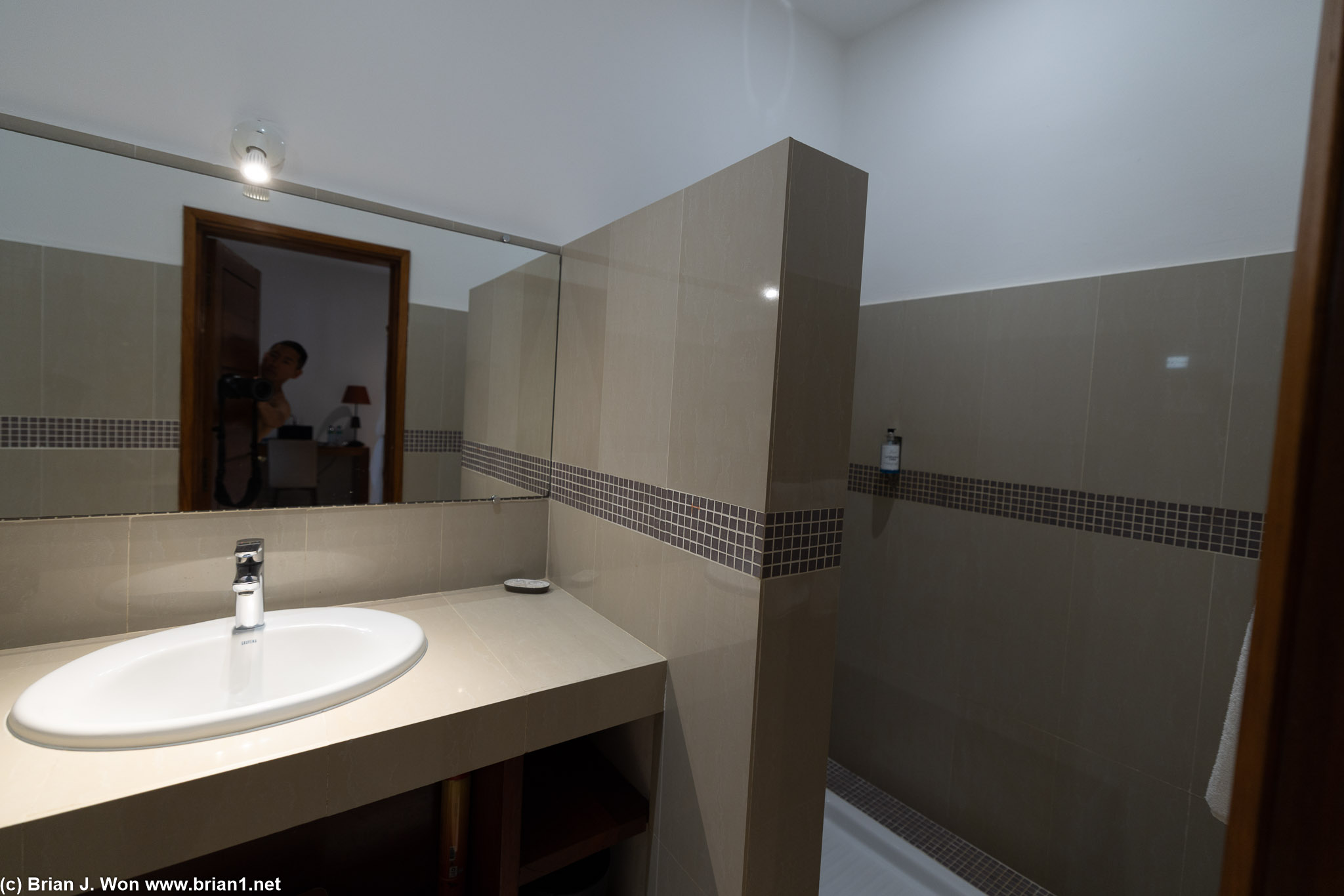 Bathroom has walls between the sink and toilet, too.