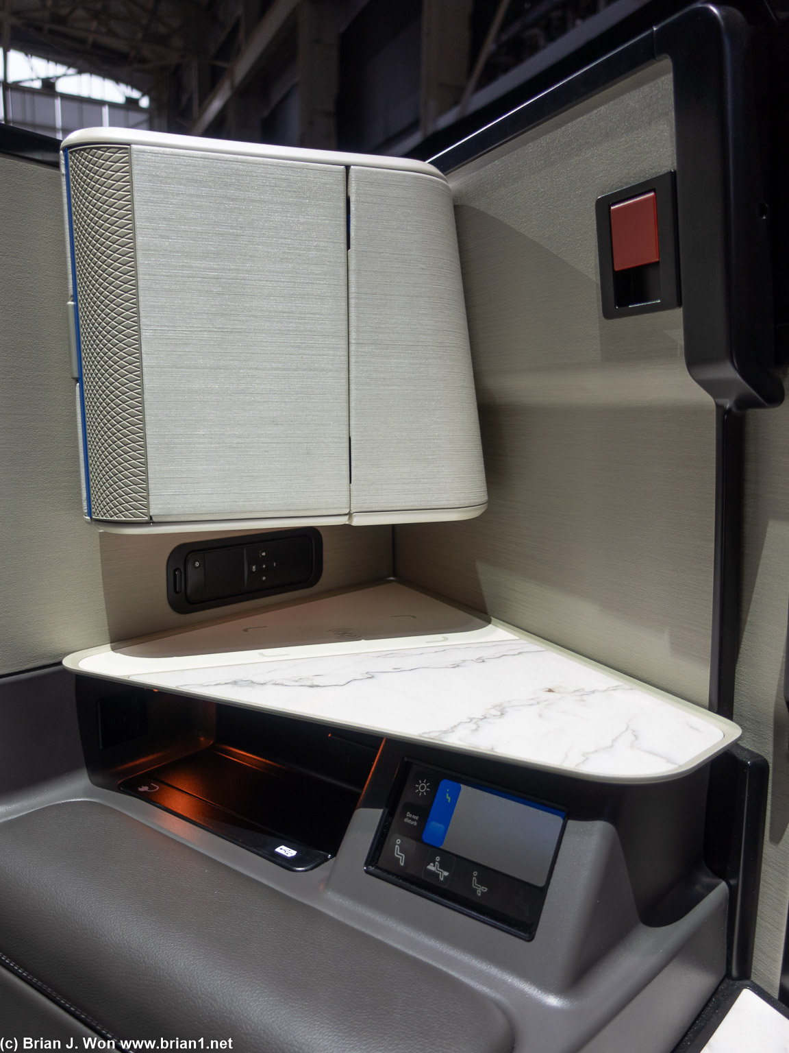 Storage: cabinet (top), shelf with wireless charging, cubby with more charging..