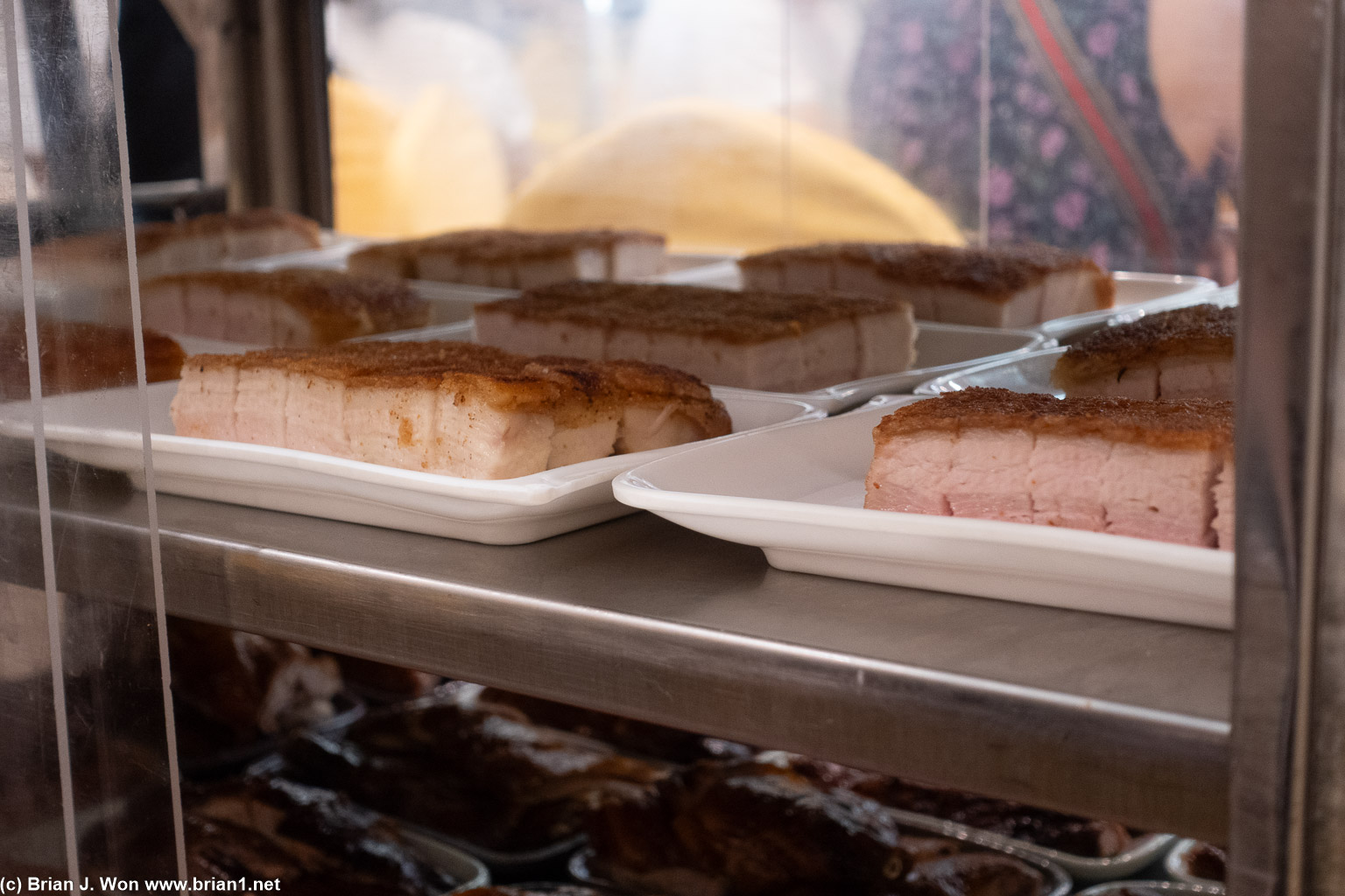 Shelf full of roast pork.