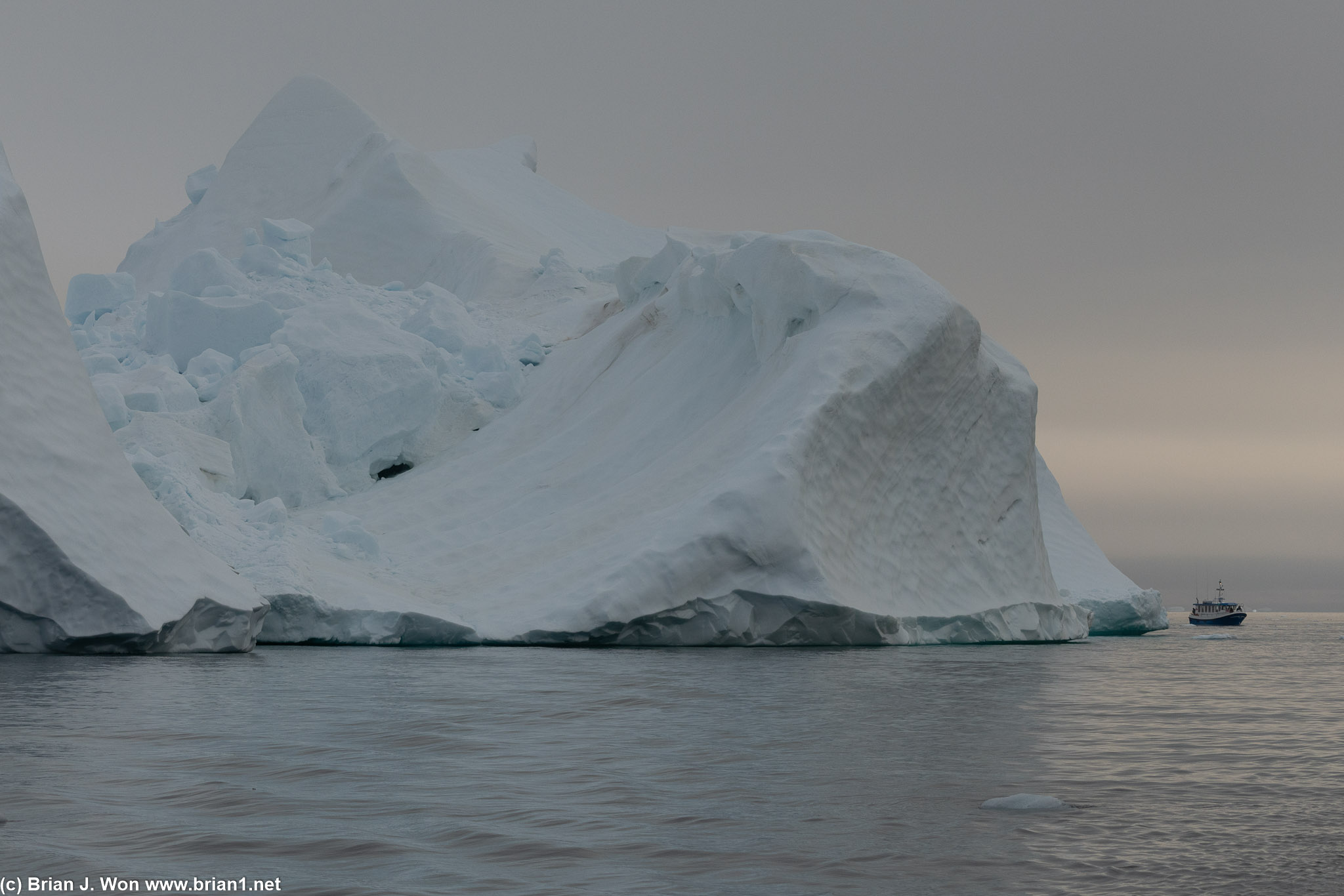 More big iceberg, little boat.