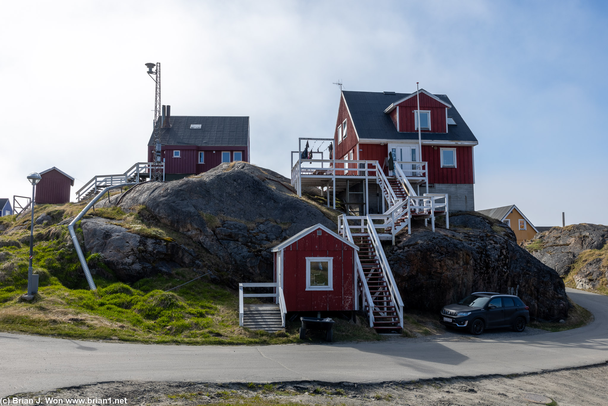 Little houses closer to the water than the hotel.