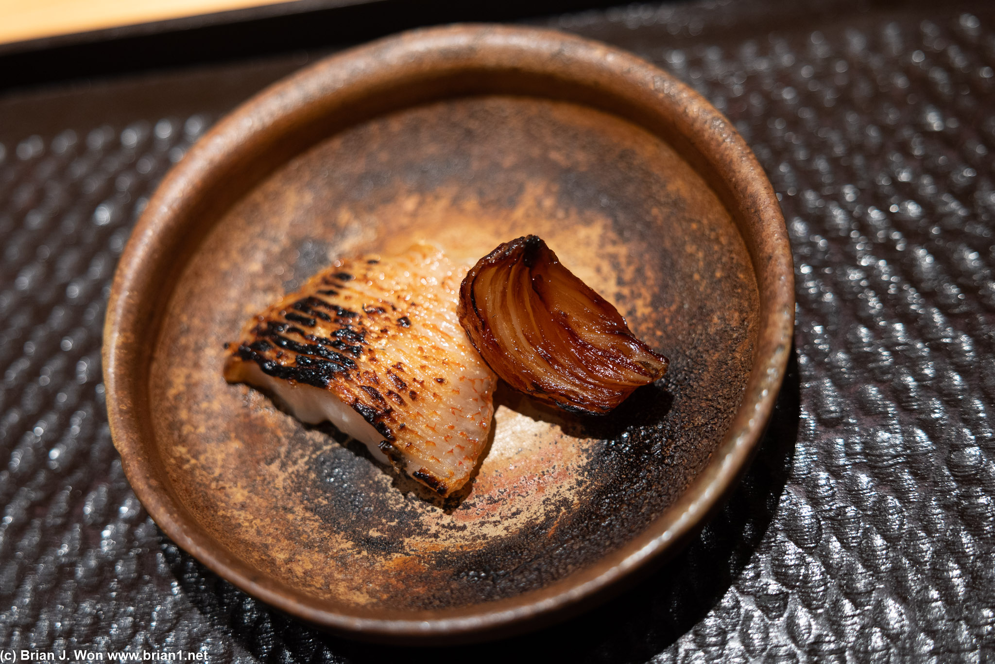 Charcoal grilled kinki (rockfish) with onion.