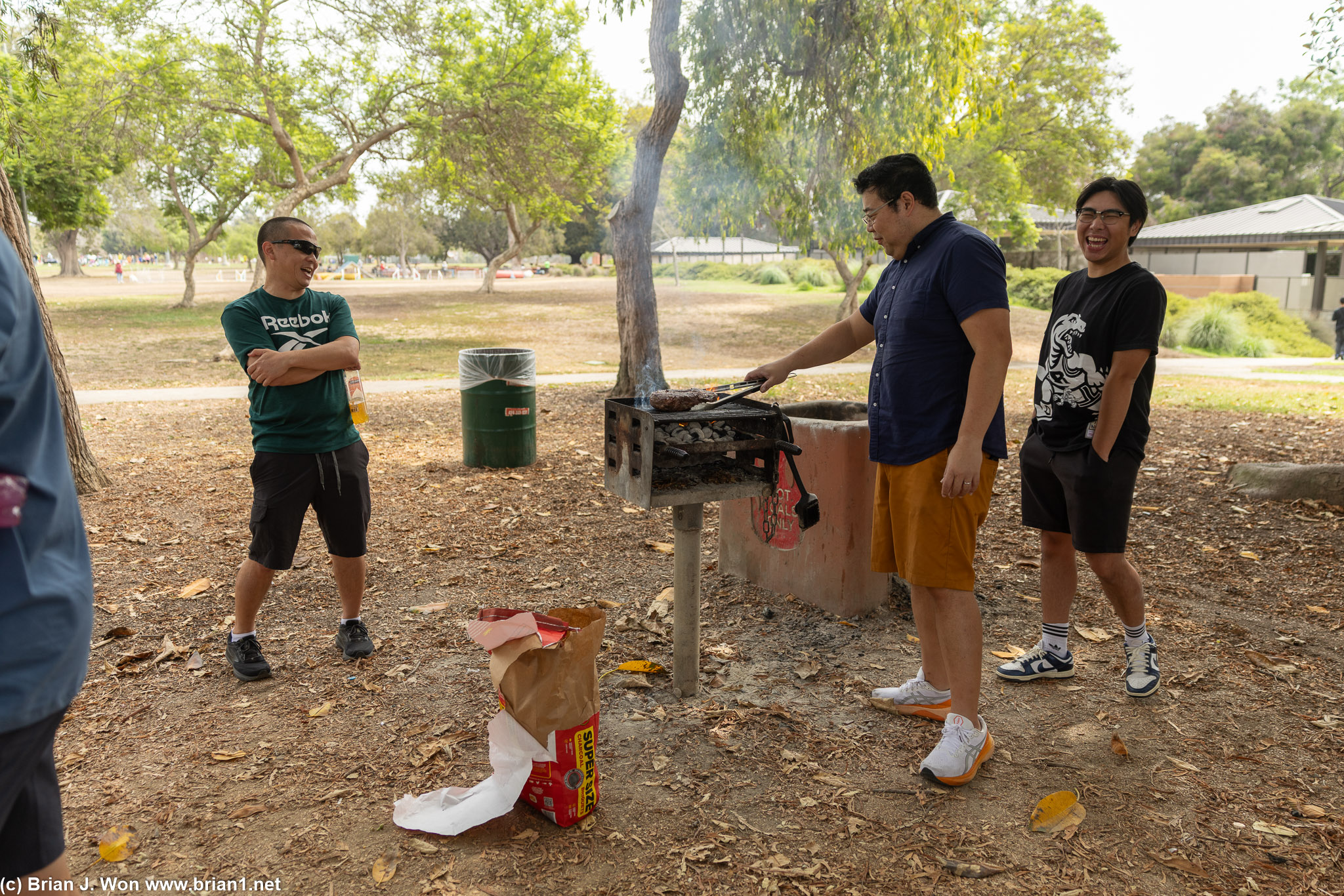 Joe working the grill while Jarett and Jason observe.