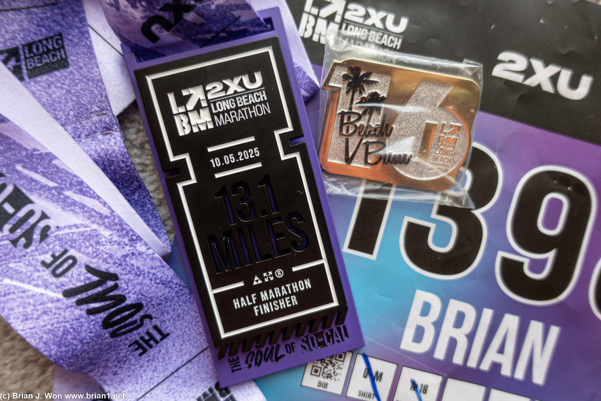 Long Beach Half Marathon finsher's medal, bib, and 16 year Beach Bum pin.